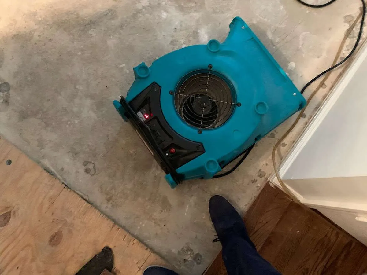 Air mover drying subfloor during Leak Detection & Repair in Carrboro